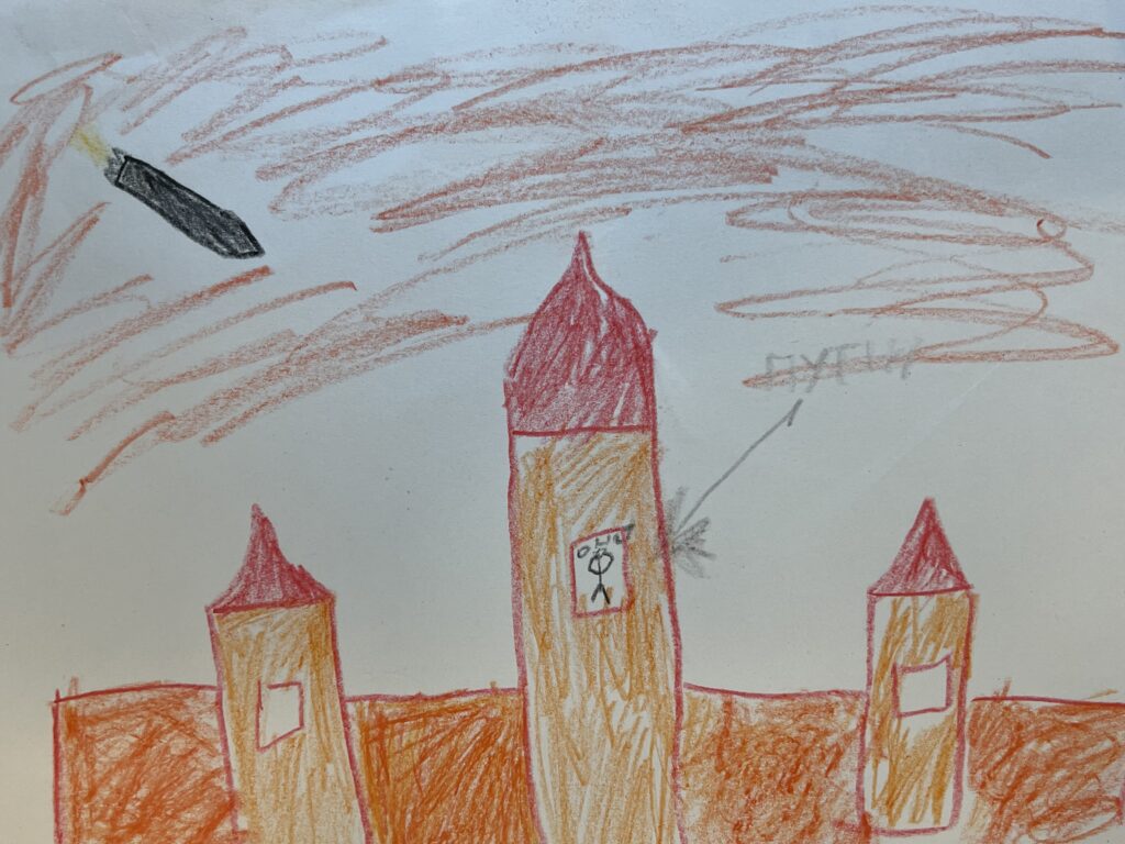 tre som hus i orange liknande torn och en raket